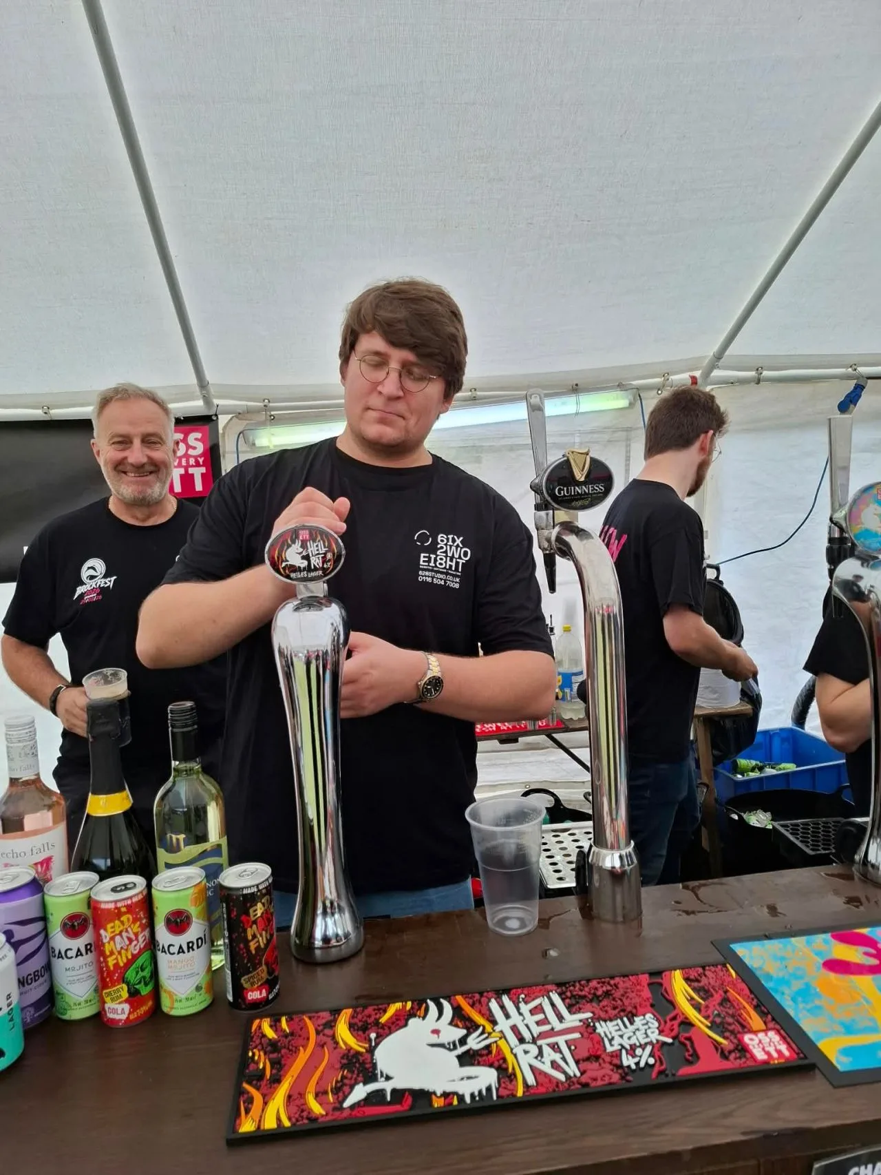 Kryspin from 628 Studio pulling a pint of Hell Rat lager behind the BrockFest bar