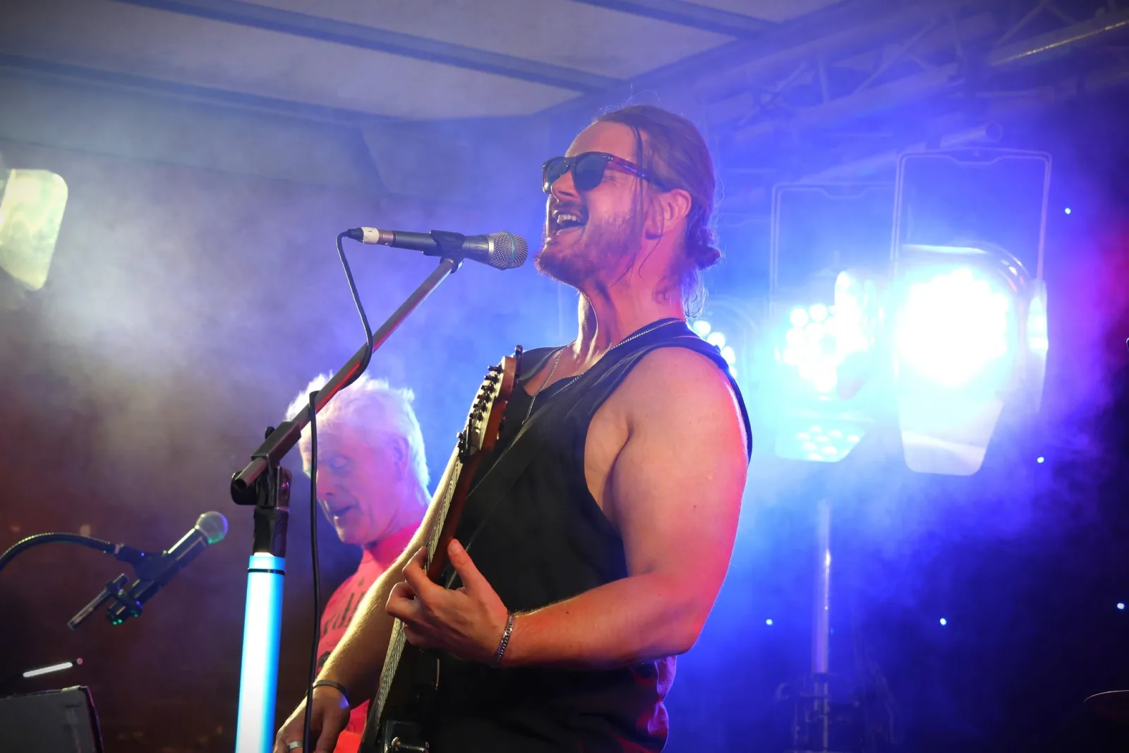 A band playing the BrockFest main stage under blue lights